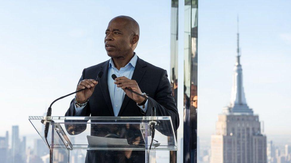 Eric Adams with the Empire State Building in the background.