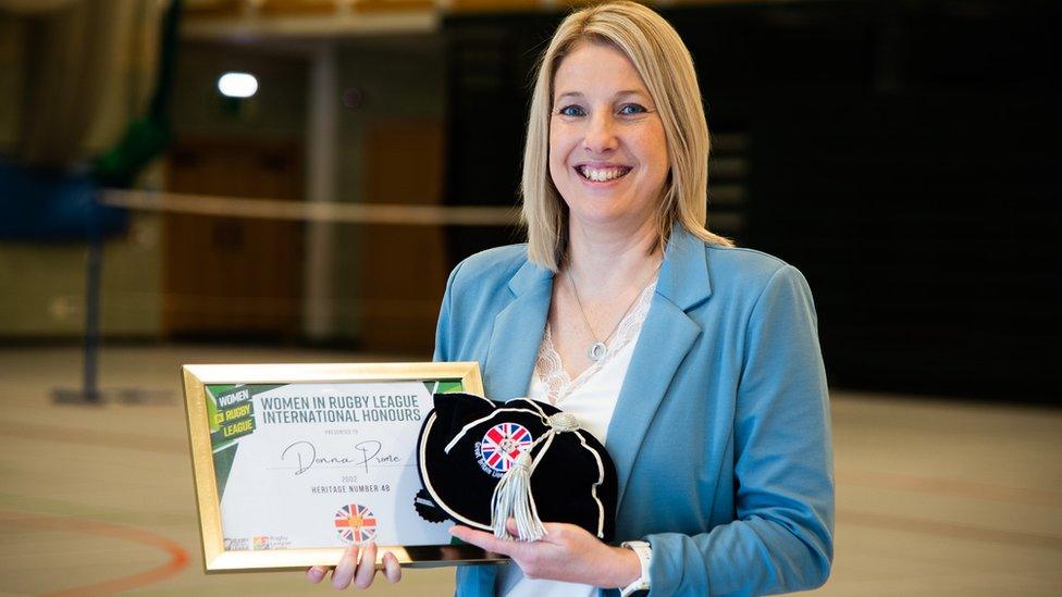 Donna Rodgers holds her cap and certificate