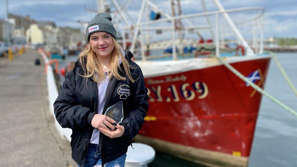 Isla Gale stood in front of boat