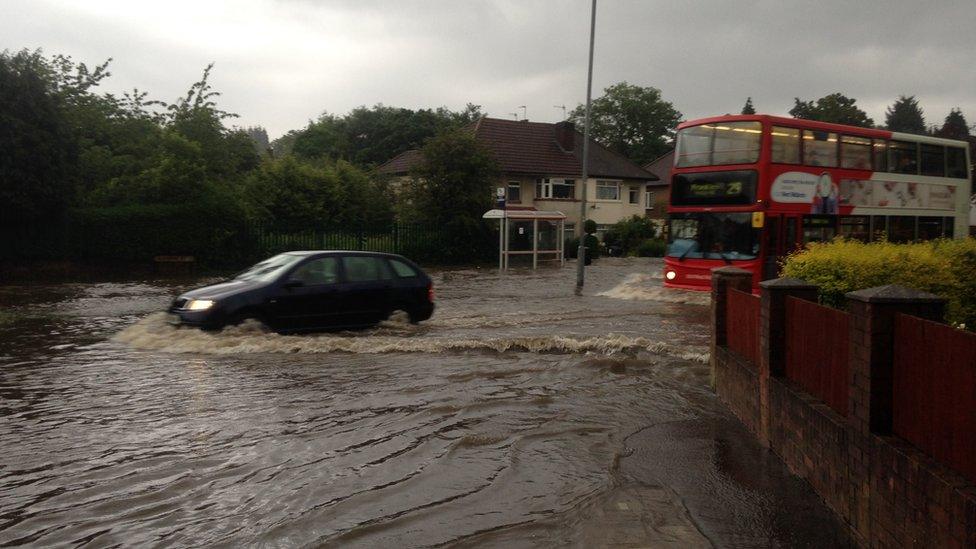 Cars trying to get along flooded Quinton Road