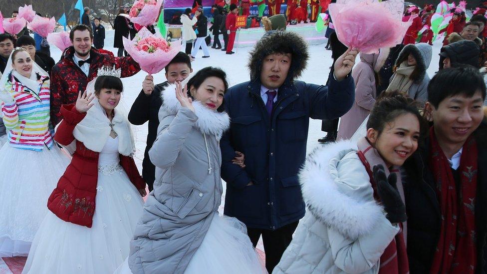 Newly wed couples attend a mass wedding ceremony at the 33rd Harbin International Ice and Snow Festival in Harbin, China's northern Heilongjiang province, 06 January 2017.