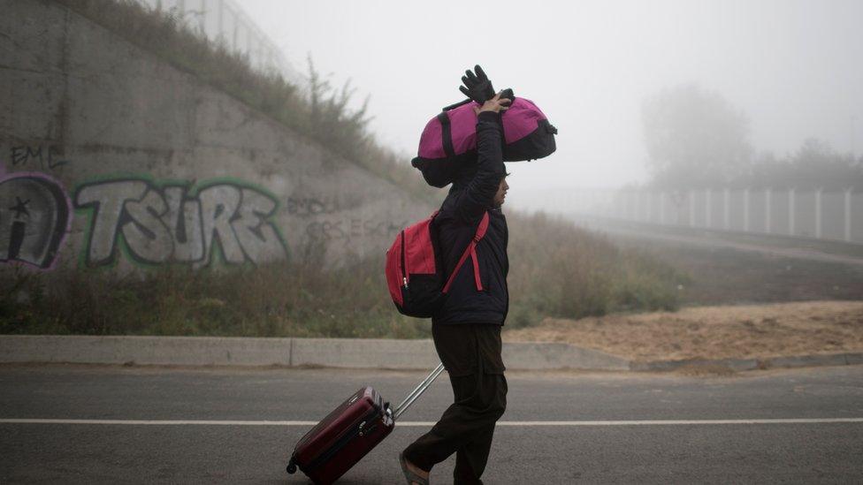 A refugee leaving the Calais migrant camp.