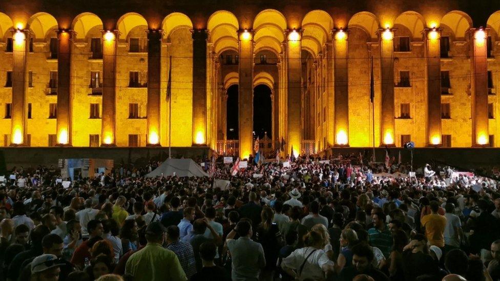 People rally outside the parliament in Tbilisi