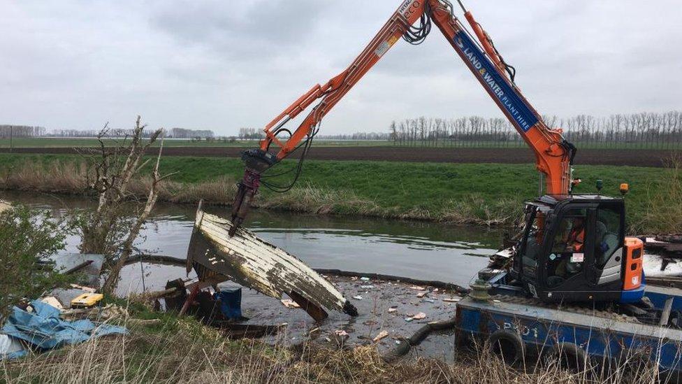 Wreckage of boat in river