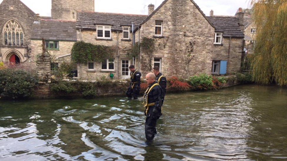 Officers searching a stream in Swanage