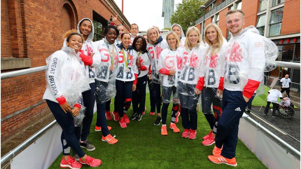 Athletes donned plastic ponchos to protect against wet weather