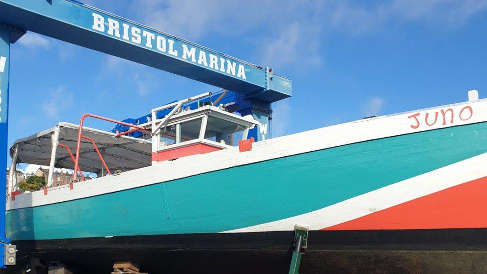 Juno, a boat painted in turquoise and red