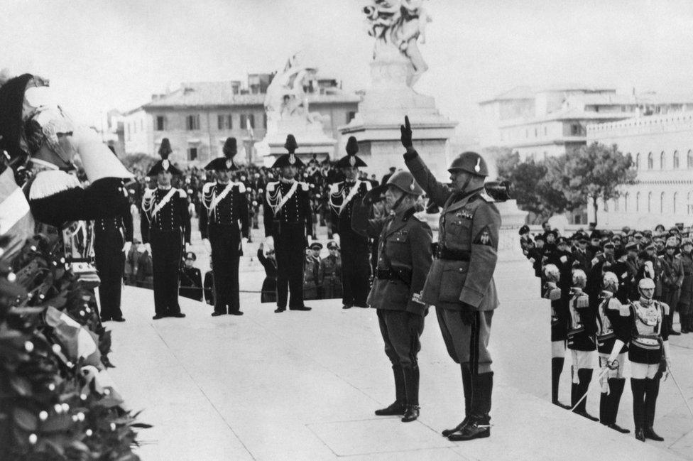 This file photo taken on 1 November 1938 shows Italian fascist dictator Benito Mussolini (right) and King Victor Emmanuel III of Italy (left) during a ceremony at the Tomb of the Unknown soldier, to celebrate the Victory day, in Rome