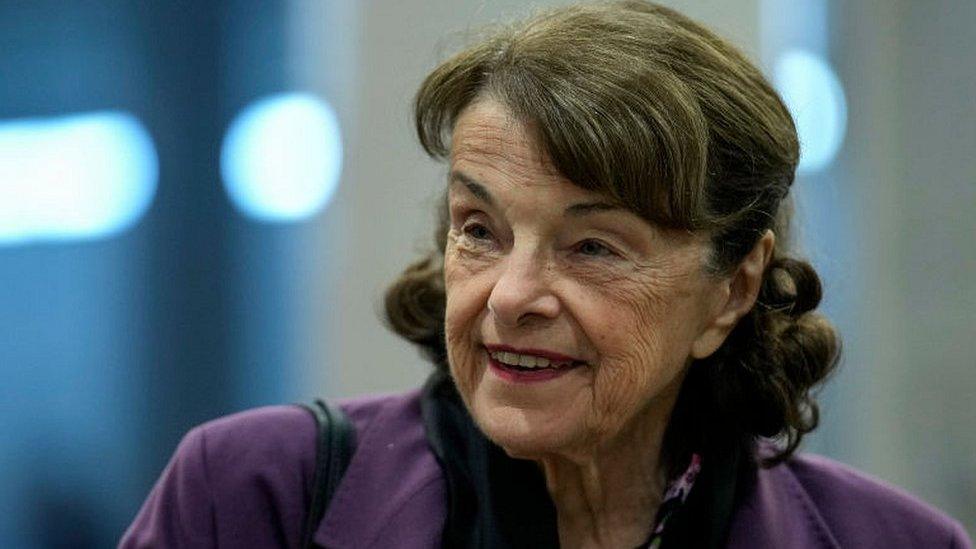 Dianne Feinstein smiles as she walks through the Senate subway in 2022