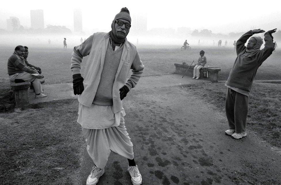 Men keep themselves fit early one winter morning at a city park in Kolkata, India