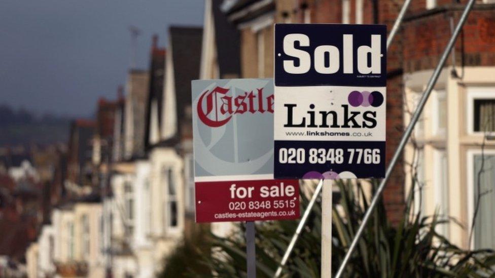 Houses and sale signs