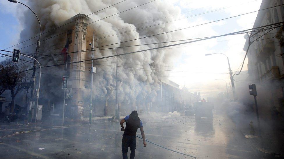 Demonstrators clash with the police