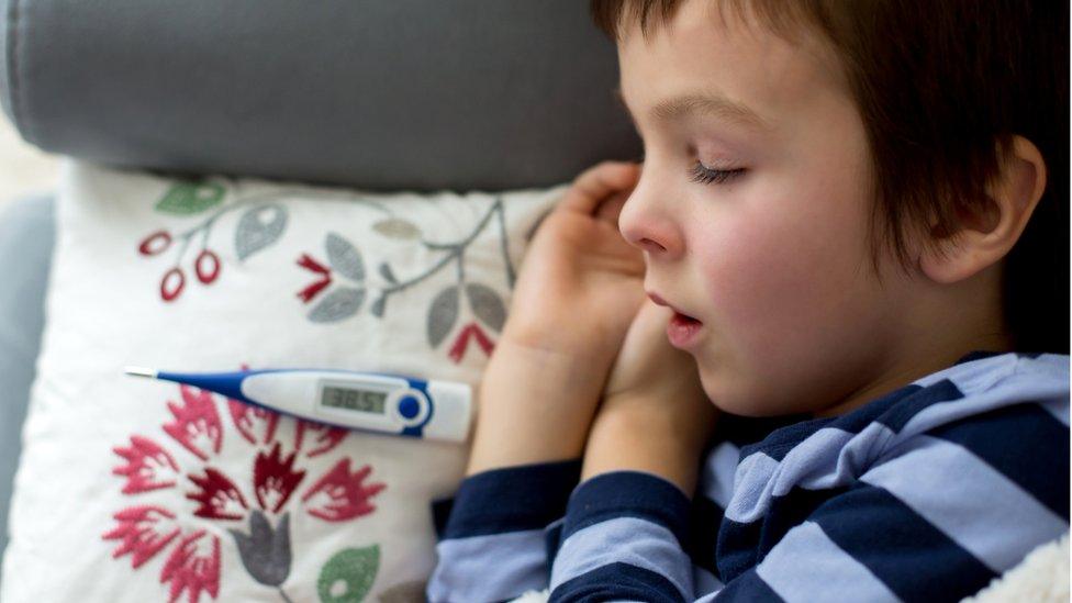 Young child sleeping after having temperature taken