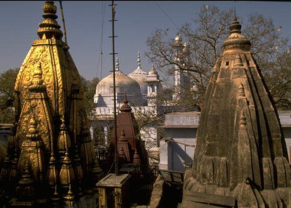 Golden top of Hindu Vishwanath temple framed by Muslim Gyanvapi Mosque, disputed Hindu Muslim site