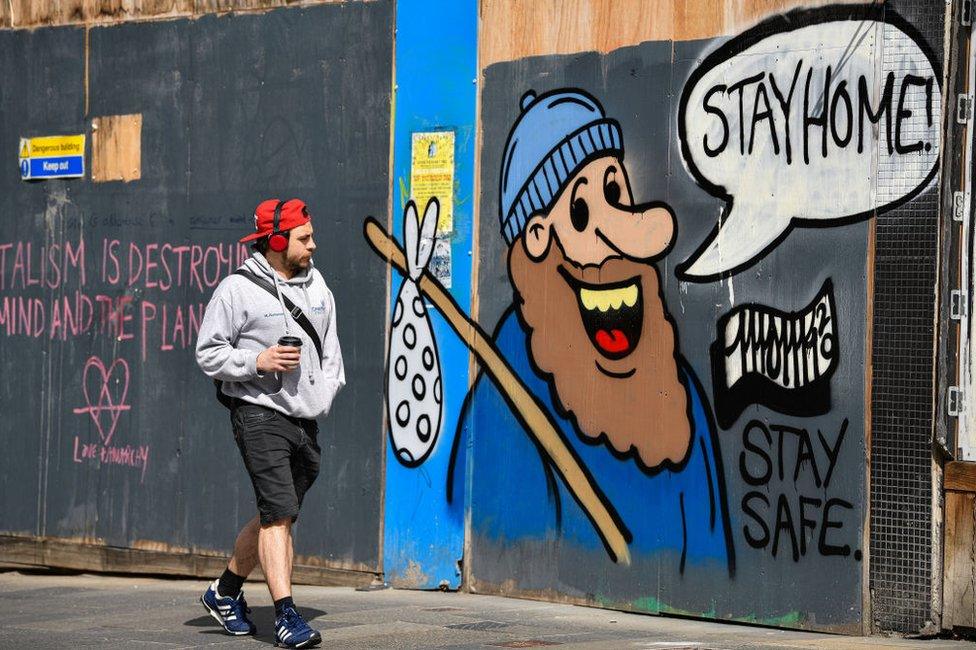 Boarded up shops on Sauchiehall Street covered by graffiti