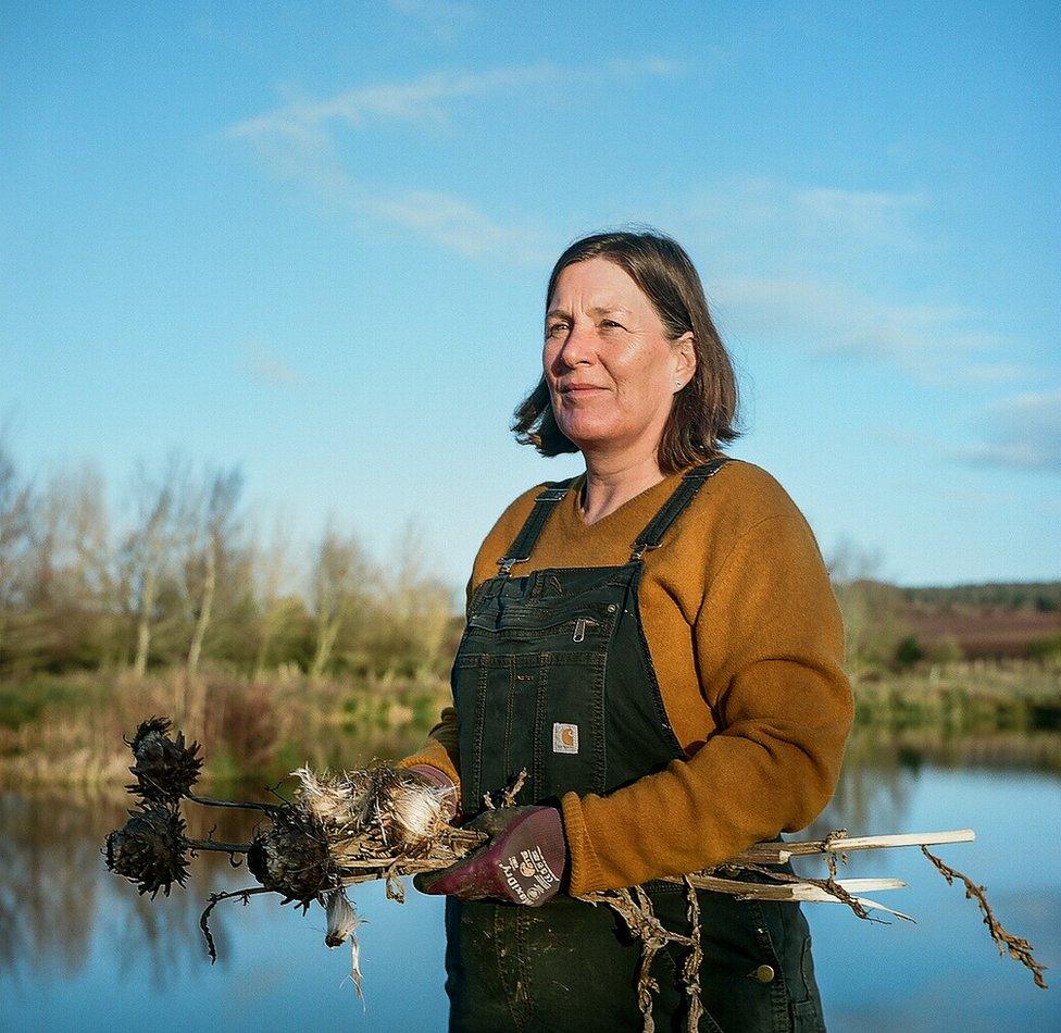 Flower farmer Paula next to a riverbank