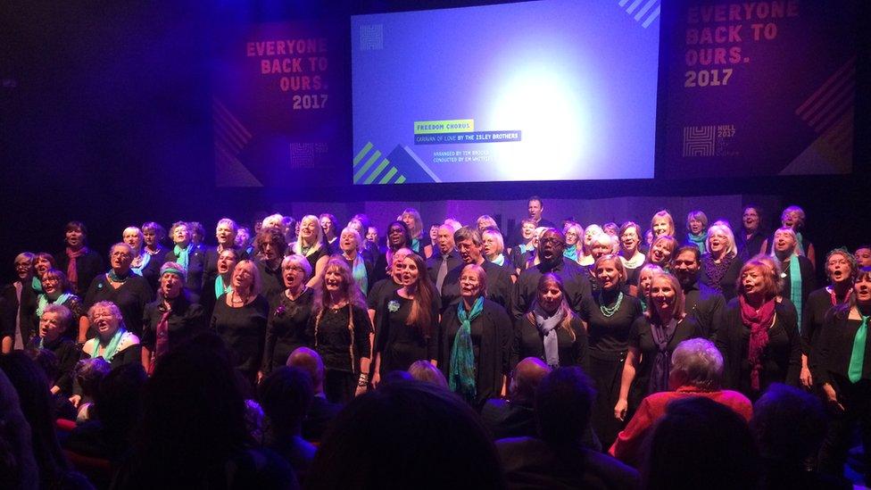 Choir singing to an audience in a theatre