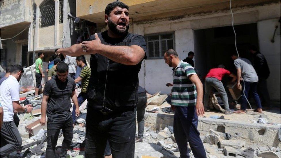 A Palestinian man reacts at the scene where a house was hit by an Israeli air strike, amid a flare-up of Israeli-Palestinian violence, in the southern Gaza Strip May 12, 2021