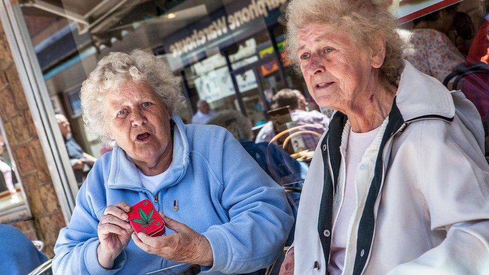 Two women sat outside cafe