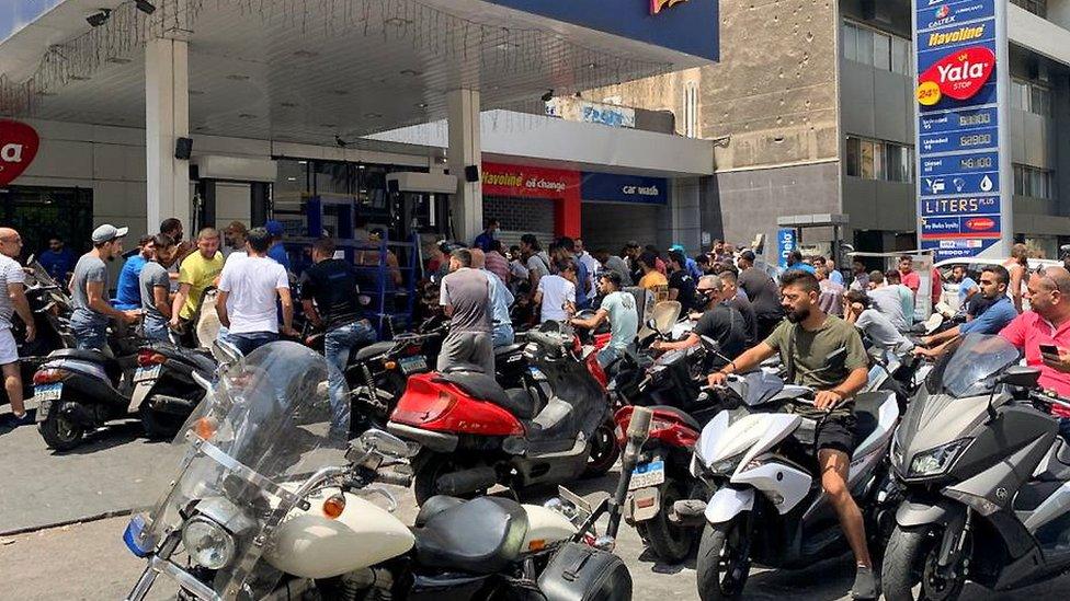 Motorbike drivers wait to get fuel at a petrol station in Beirut, Lebanon (29 June 2021)