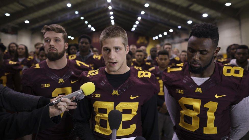 University of Minnesota wide receiver Drew Wolitarsky (centre), reads a statement on behalf of the players in the Nagurski Football Complex in Minneapolis, Minnesota, 15 December 2016