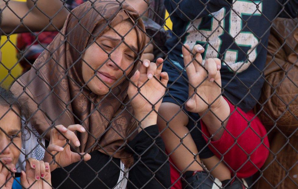 Migrants protest outside a train that they are refusing to leave for fear of being taken to a refugee camp in Bicske, near Budapest, Hungary