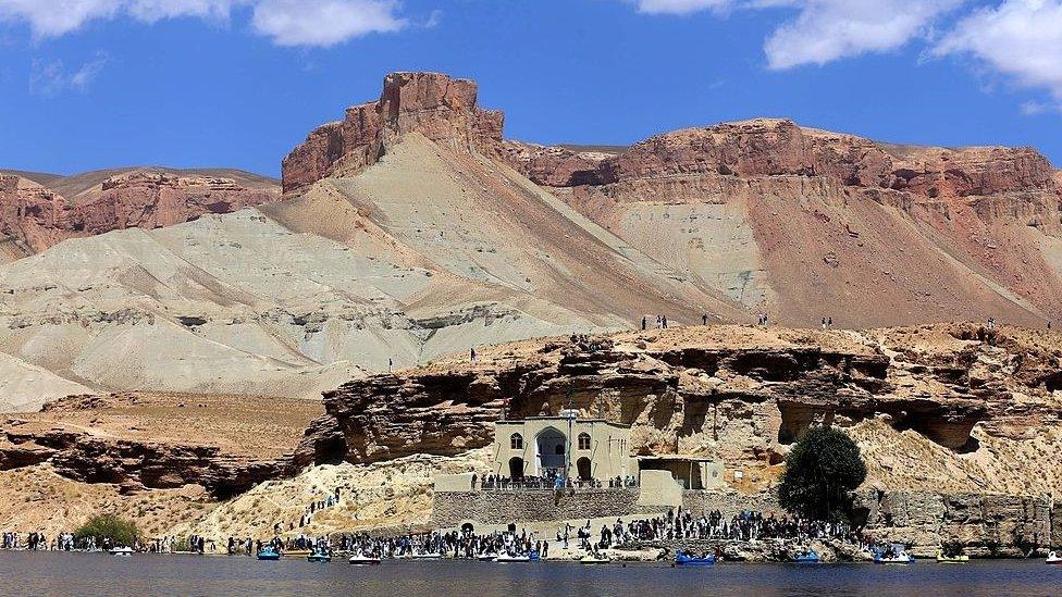 Afghan tourists are pictured at the water's edge of the Band-e Amir lake on the outskirts of Bamiyan on August 29, 2014