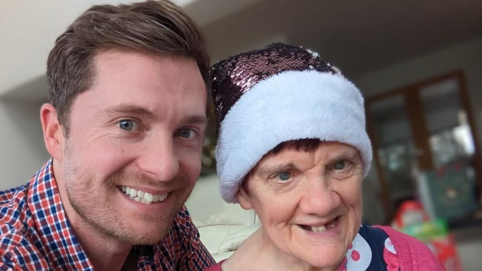 Ms Sharpe with a glittery Santa hat on in a selfie with her nephew