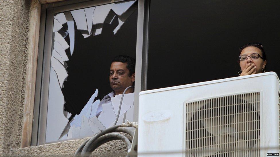 Residents look at the site of a car bomb attack on the convoy of Egyptian public prosecutor Hisham Barakat near his house at Heliopolis district in Cairo, Egypt, 29 June 2015.