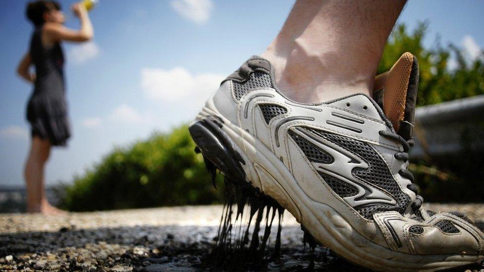 A melted road stuck to a training shoe