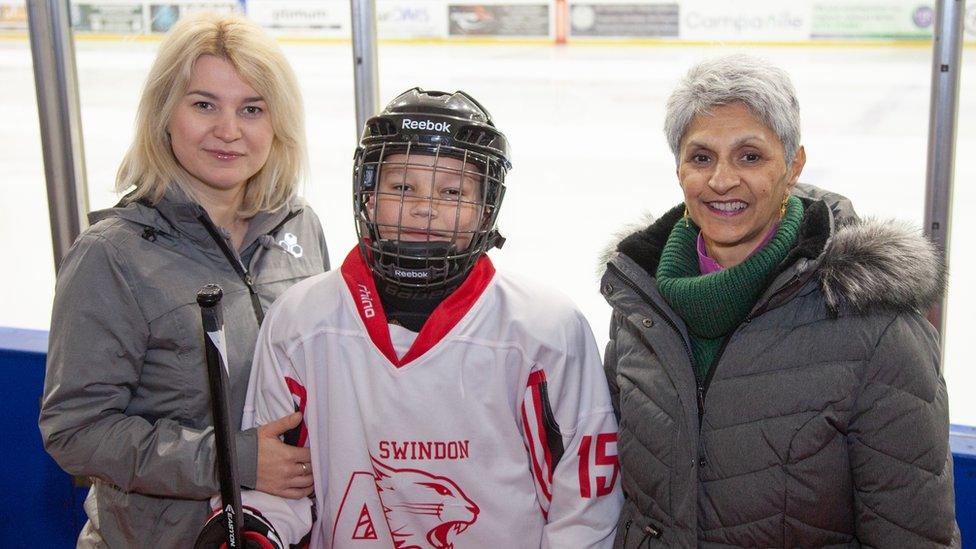 Kateryna, Myron and Bindoo Rattan (L-R) stand in front of an ice rink