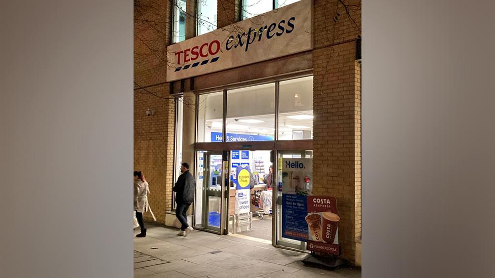 Tesco express entrance with people outside