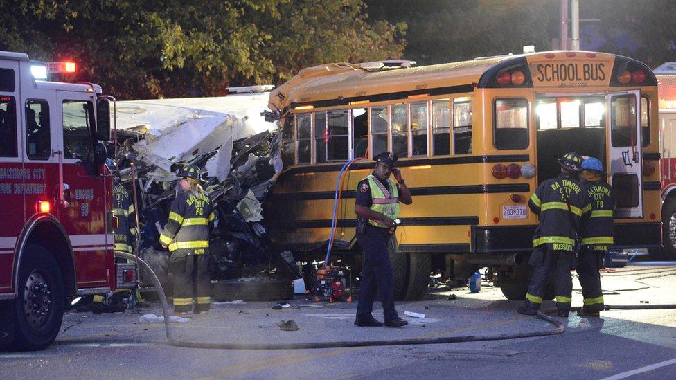 Rescue officials at the scene of an early morning collision between a school bus and a commuter bus in Baltimore