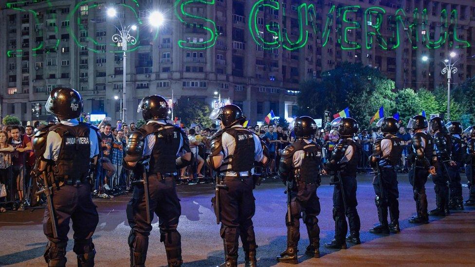 Romanian police form a line at an anti-government rally in the capital Bucharest, on August 11, 2018