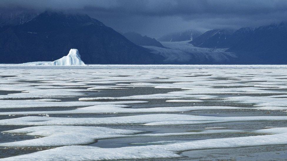 50 metre tall iceberg trapped in the frozen sea of Eclipse Sound Baffin Island, Canada