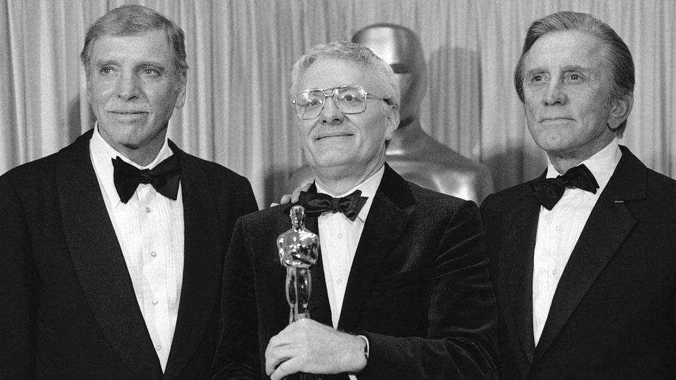 Actors Burt Lancaster [L] and Kirk Douglas [R] presented Sir Peter with his Oscar in 1985 for Amadeus