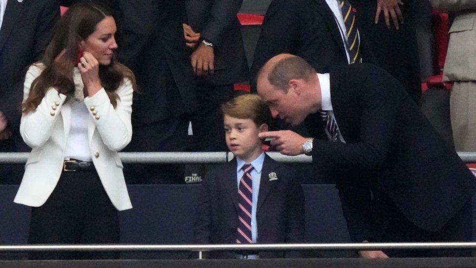 Prince William talks to Prince George at Wembley