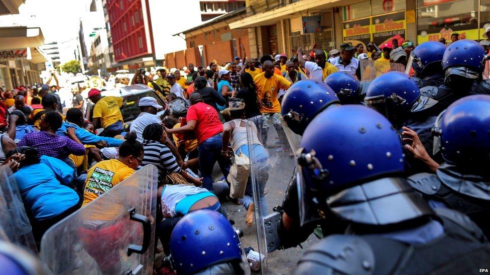 South African protestors clash with police ahead of the opening of parliament ceremony in Cape Town