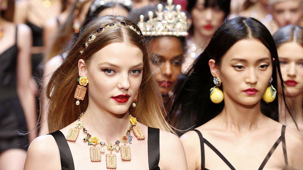 Models in a Dolce & Gabbana show in 2018