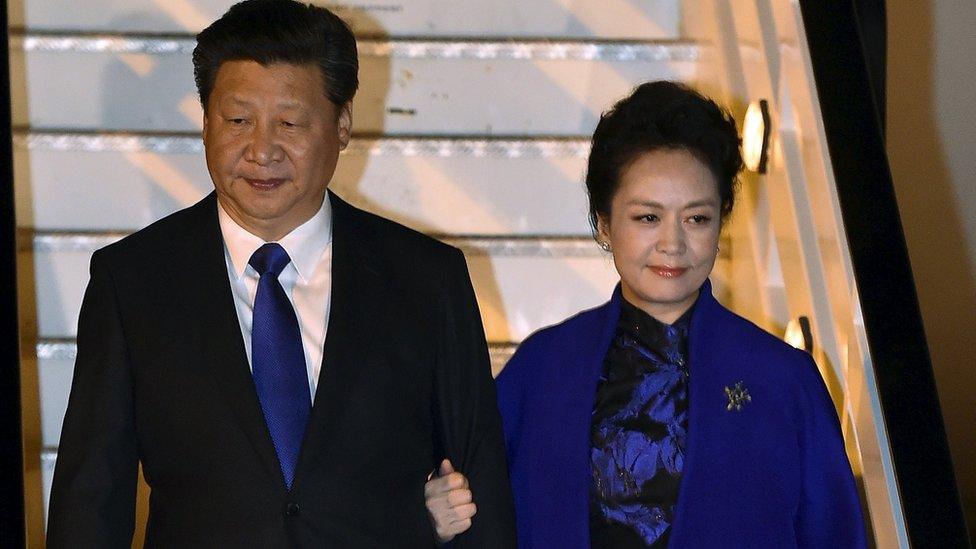 Chinese President Xi Jinping and his wife Peng Liyuan arrive at Heathrow airport