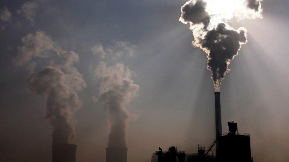 A coal-burning power plant behind a factory in the city of Baotou, in China's Inner Mongolia Autonomous Region