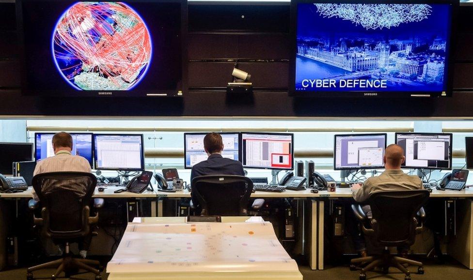 People sit at computers in the 24 hour Operations Room inside GCHQ, Cheltenham on 17 November, 2015.