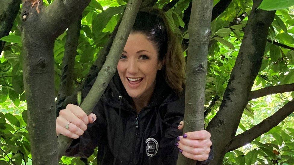 Katy Hancock hiding in a tree