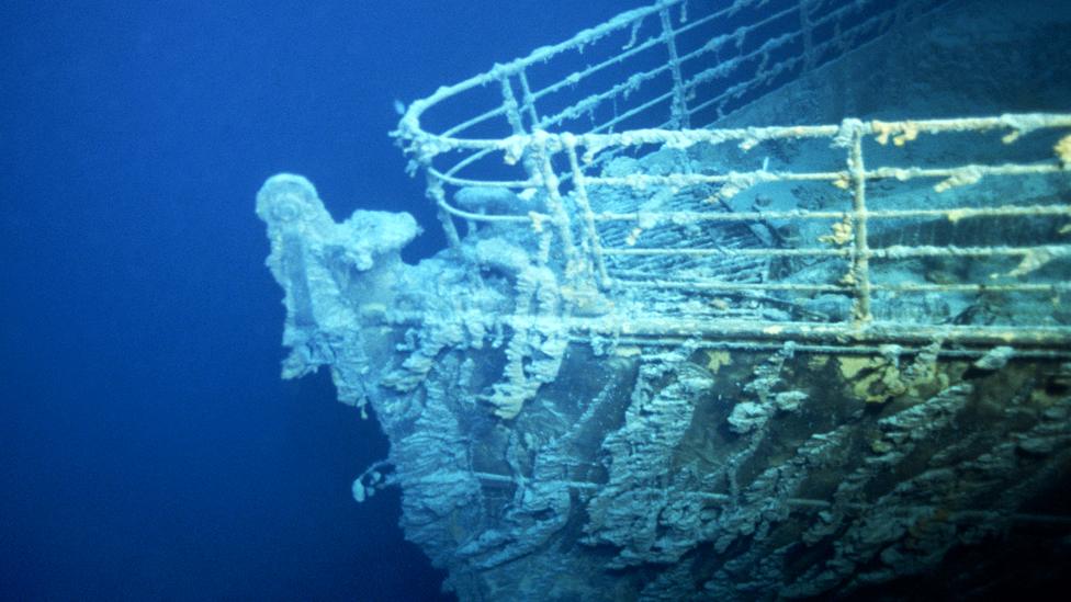 The bow of the wrecked Titanic with sea life clinging to the railings