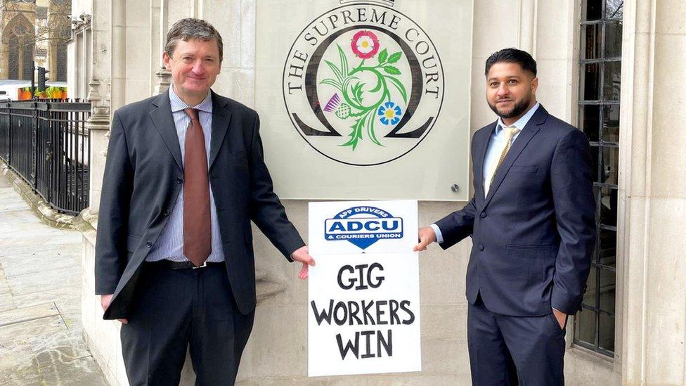 Former Uber drivers James Farrar and Yaseen Aslam pose in front of the Supreme Court on Friday