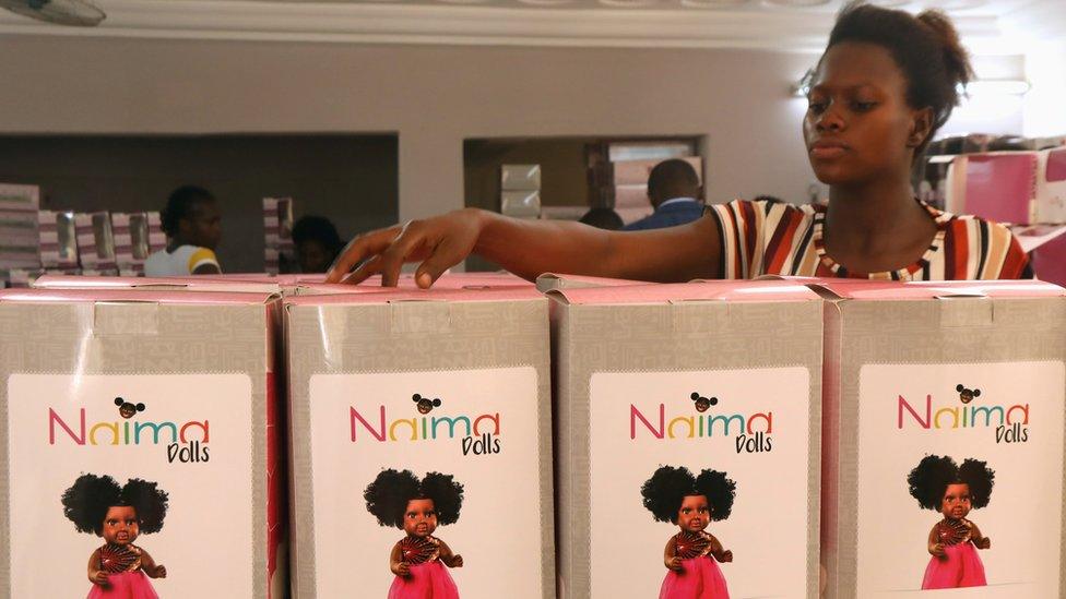 An employee packs Naima dolls to reach lucky children in time for Christmas