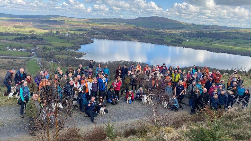 Large group of walkers and dogs taking part in sponsored walk with Max, paddy and Harry