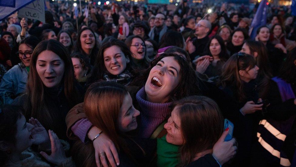 Members of the public react as the French abortion vote results are announced. French lawmakers have made abortion a constitutional right.