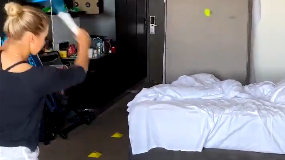 Tennis player Yulia Putintseva of Kazakhstan hitting a tennis ball in her hotel room during coronavirus quarantine