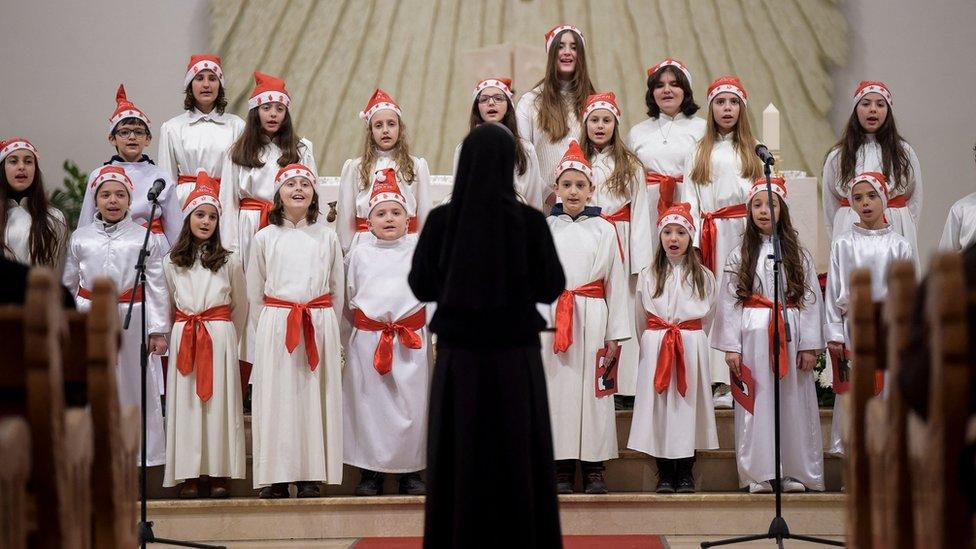 Children perform at the Mother Teresa Cathedral during the midnight Christmas mass in Pristina on December 25, 2021.